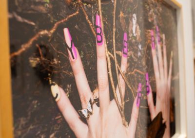 A photo of a framed photo of hands. The photo has been taken on an angle and cropped, distorted the framed photo