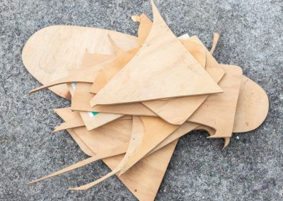 a pile of plywood scraps photographed onto of bitumen